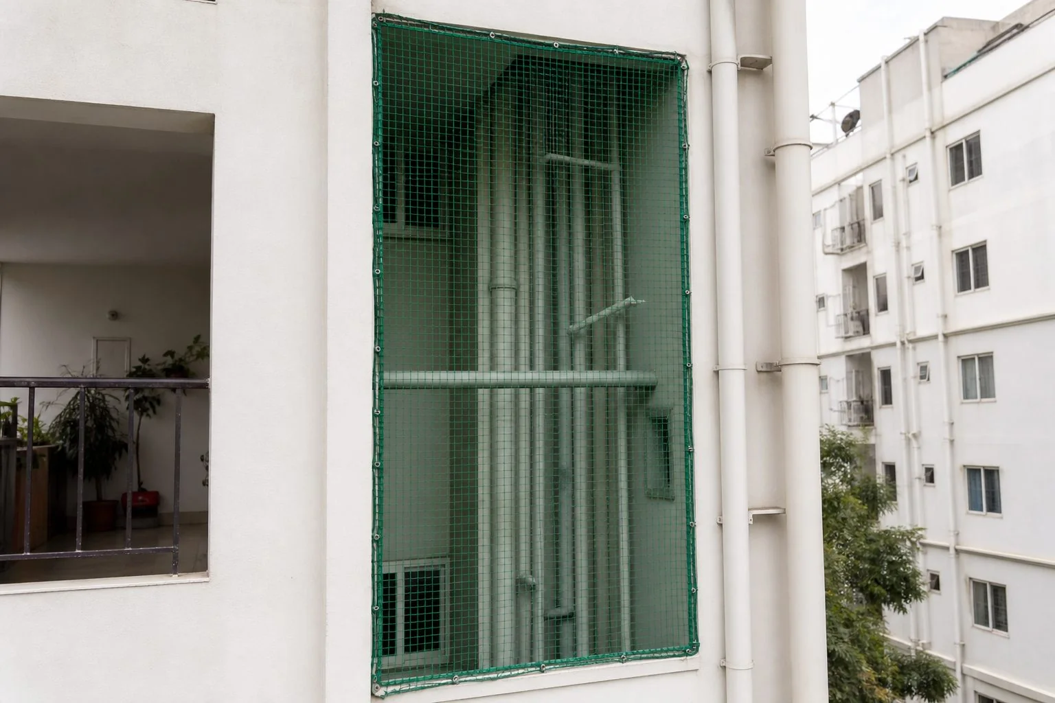 After outside vertical duct safety net installation finished across pipe shaft in Hyderabad