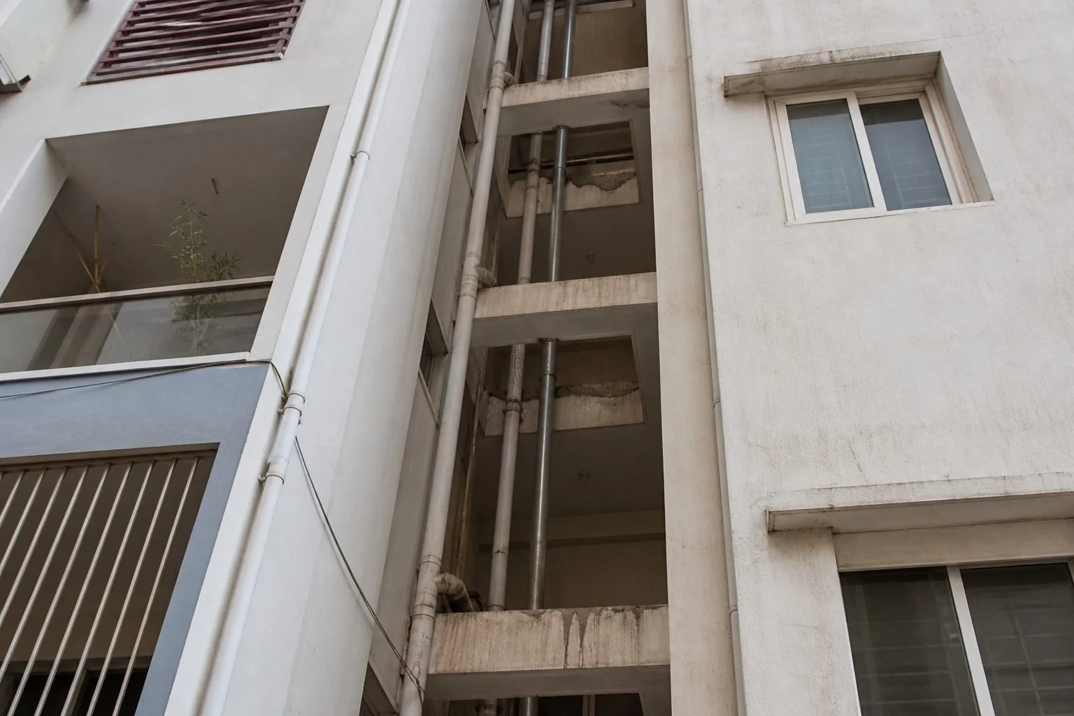Before outside vertical duct safety net installation on apartment pipe shaft in Hyderabad